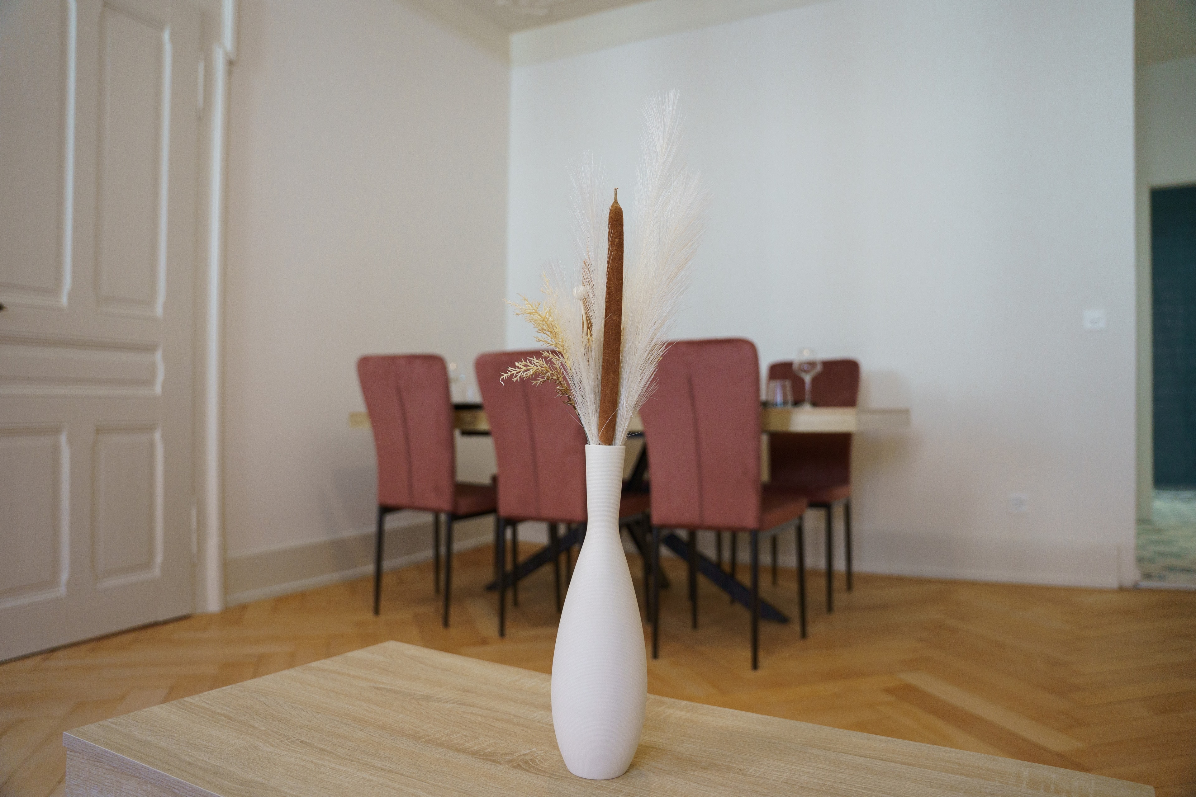 Dining room of the Apartment, pink chairs and herringbone parquet