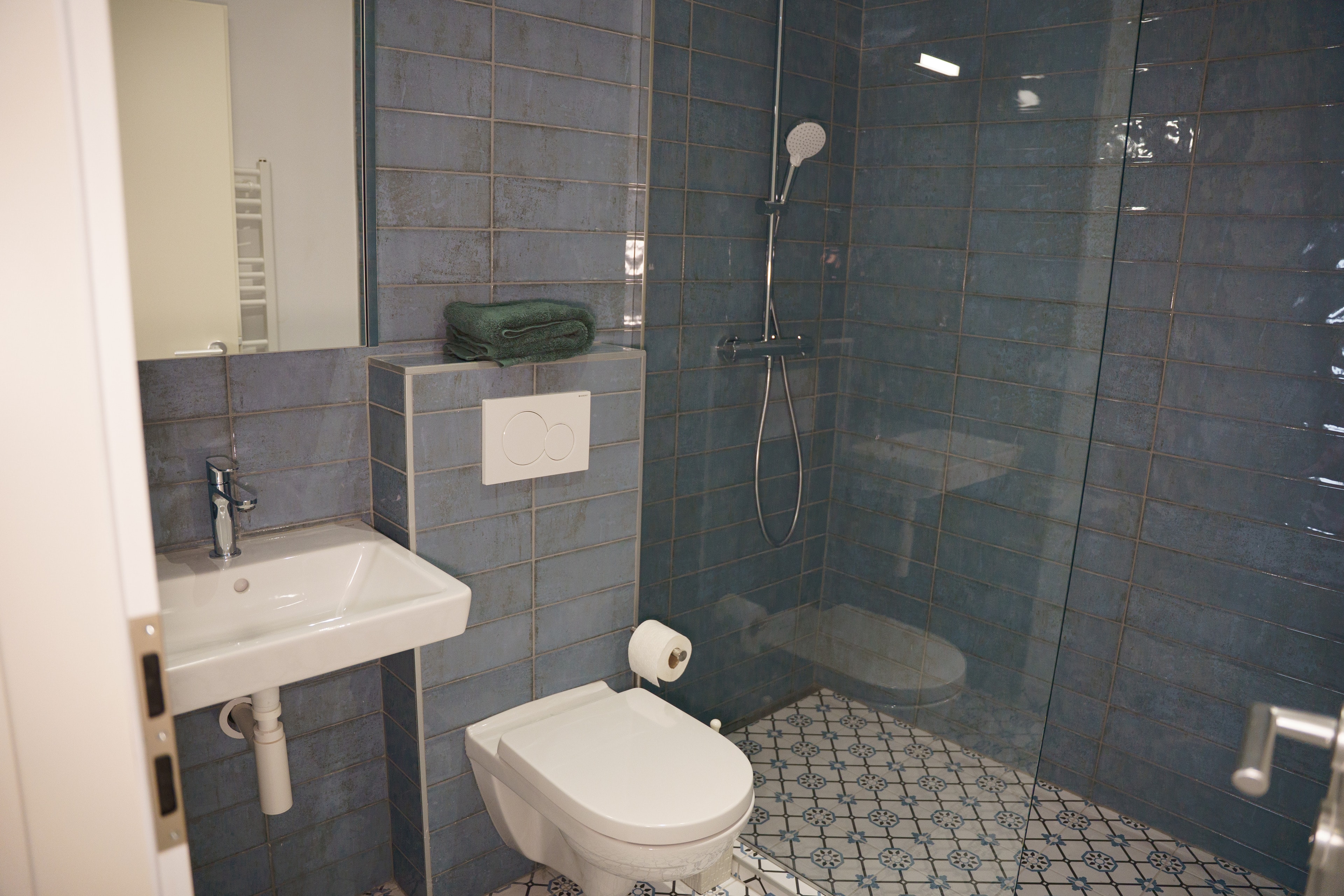 Tiled bathroom of the Apartment with a walk-in shower
