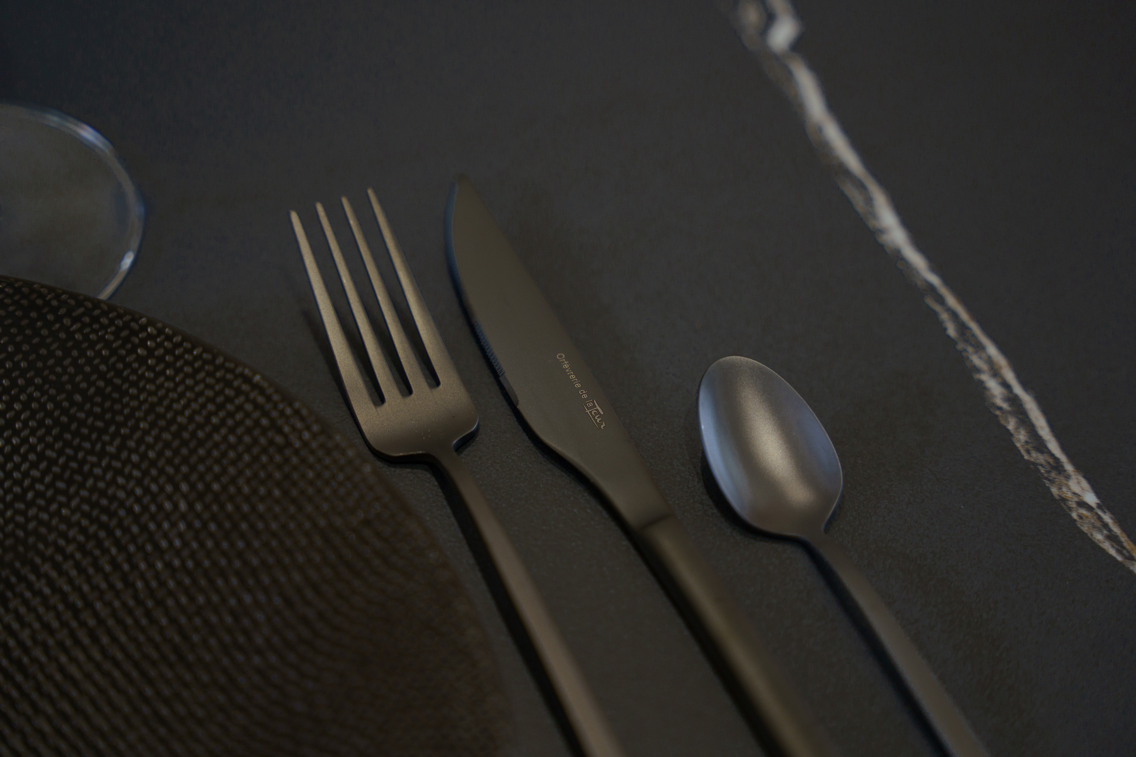 Metal cutlery on a dark Rooftop table