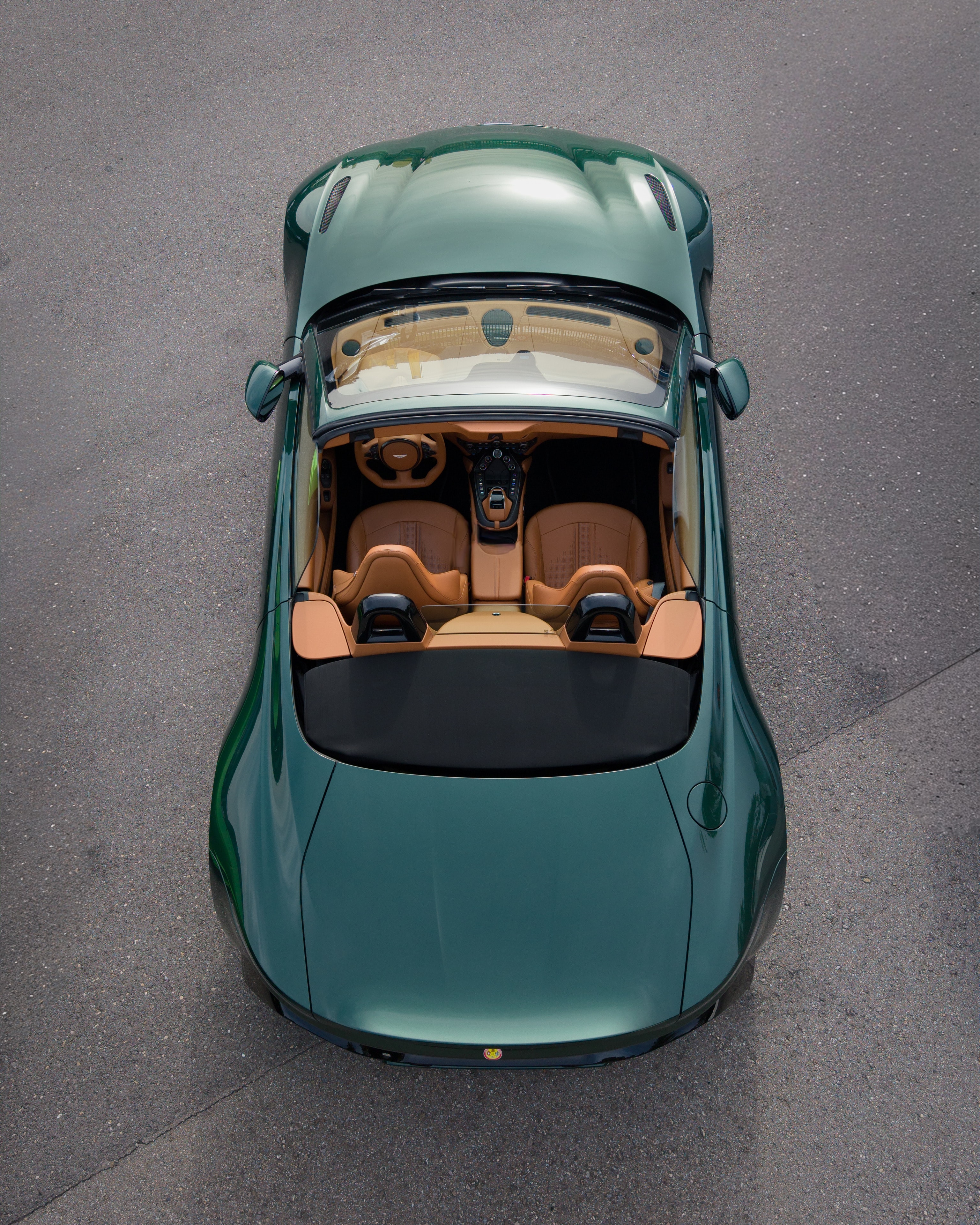Green Aston Martin convertible shot from above by drone