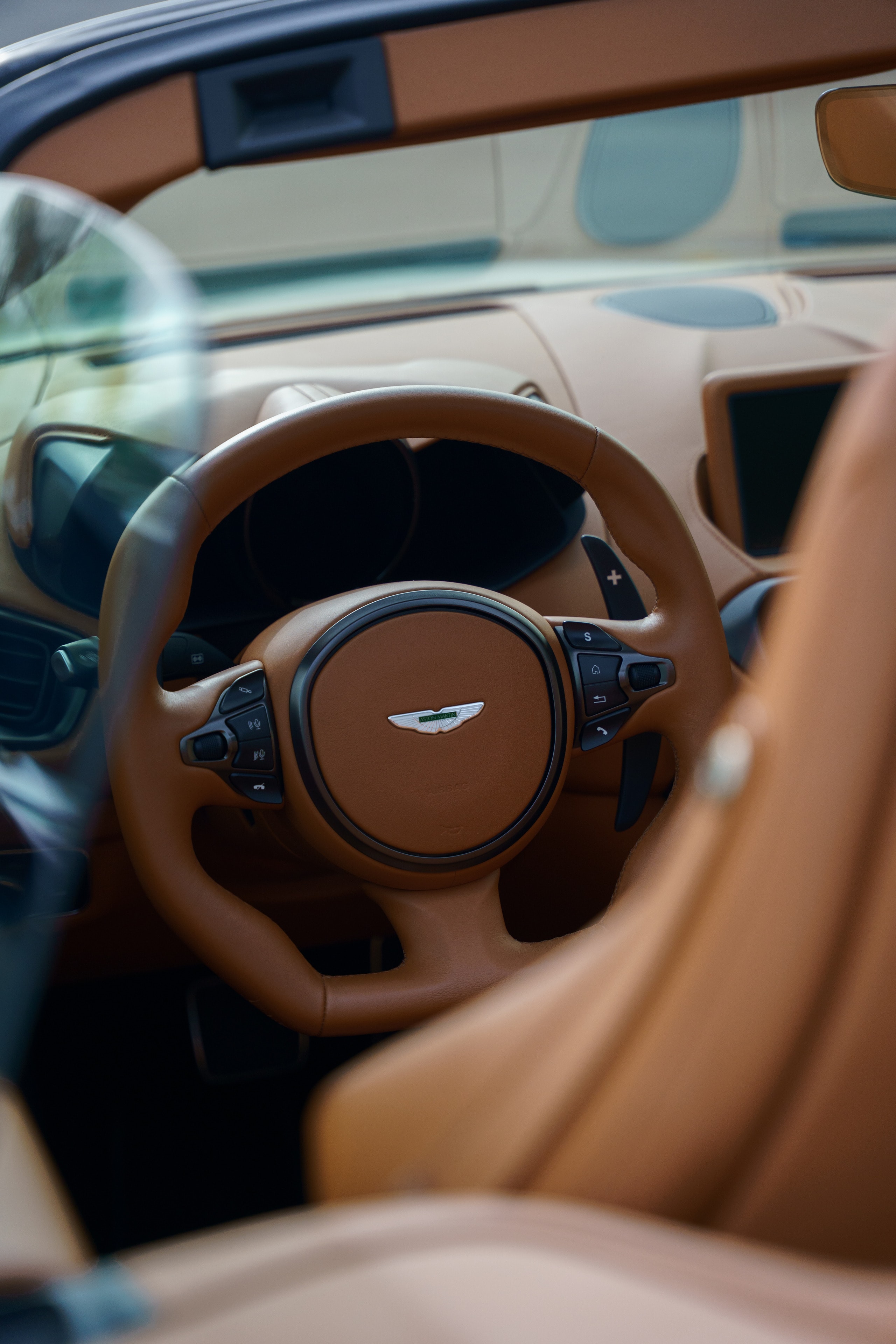 Steering wheel and leather interior of an Aston Martin